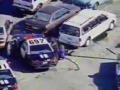 Officers rescue Officer Stuart Guy with one of the police cars.