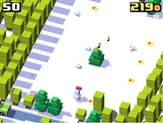 The Festive Chicken in a clearing with the Christmas tree.