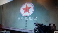 The Korean People's Army Air and Anti-Air Force roundel insignia sticker on the KPA barracks exterior wall.