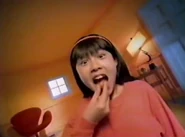 Another child putting a gusher in her mouth.