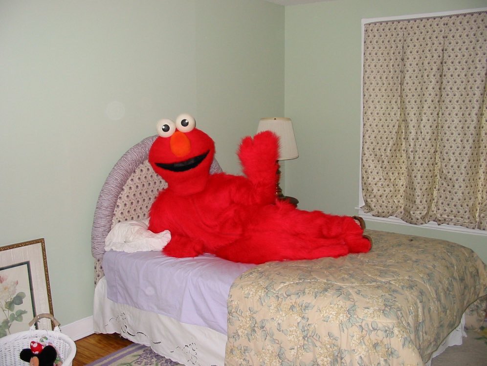 Elmo Waves on Bed.