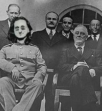 Geddy Lee and US President, FDR watch as dissidents are fed to the raptors, circa 1936