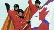 The flag of Disparu is carried into the Olympic Stadium during the XXI Olympic Winter Games.