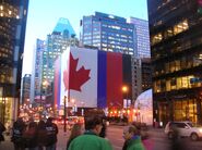 The flag painted on a building facing an intersection in Montréal, in support of the Disparuean team at the Olympics.