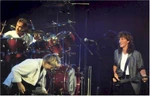 Rush (The Priests) playing at a concert in Tamagotchi City in 1984, during the Grace Under Pressure Tour