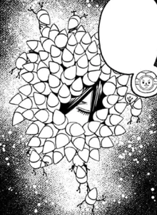 Koki's floating head surrounded by the pygmies.