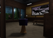 An enclosed room with a dinosaur exhibit on one side and a dinosaur comparison chart