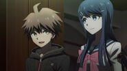 Makoto and Sayaka converse while Hope's Peak Academy is being converted into a shelter.