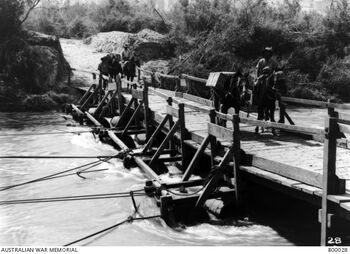 Australian soldiers with pack horses, crossing the barrel bridge at Auja, in the Jordan Valley