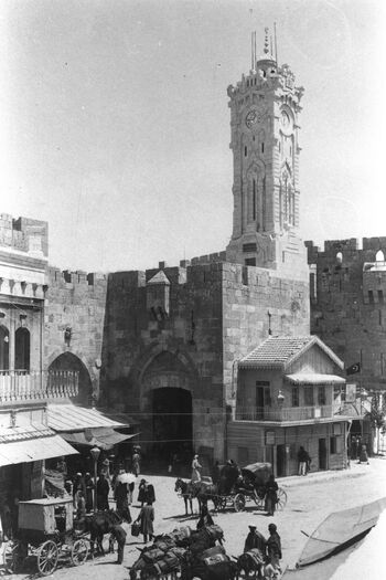 RARE PHOTO OF JAFFA GATE IN JERUSALEM WITH THE CLOCK TOWER ABOVE AND THE TURKISH CUSTOMS OFFICE (WITH TILED ROOF) BESIDE IT, DURING THE OTTOMAN ERA