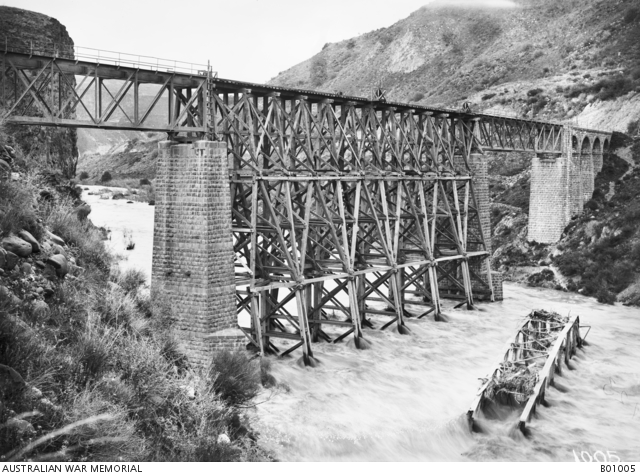 A railway bridge over the Yarmuk River, destroyed by the enemy and rebuilt by the Canadian Bridging Company. Note the destroyed section lying in the past flowing river. February 1919