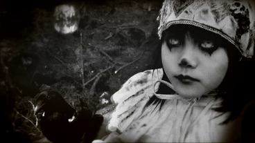 The black-haired girl looks to the camera.