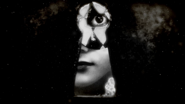 The girl looks through the keyhole.