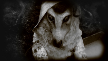 The girl finds a masked figure inside the chest.