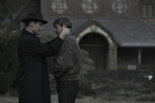 DARK Still 110 - Noah and Helge outside church