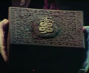 A carved Naga on the lid of the box.