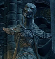 A statue of the Primordial Serpent inside Lothric.