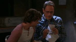 Orpheus shows a photo of Zoey and her son to Joey Johnson.