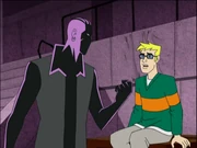 A black and purple man who resembles a shadow holding up his fist in front of a white male teenager.