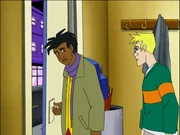A black teenage boy opening a door while a white teenage boy looks at him.