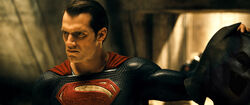 Superman holding Batman's cowl