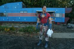 Peacemaker outside his trailer
