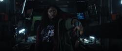 Adebayo grabs a gun and prepares to help the team