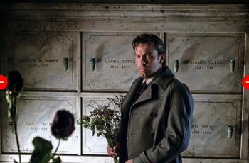Bruce stands in the Wayne mausoleum