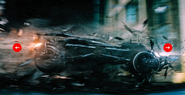 Batmobile crashing through rubble