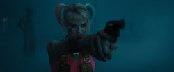Harley pointing a gun at Roman