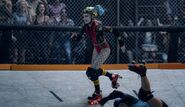 Harley Quinn rollerblades in rink