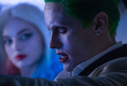 Harley Quinn watches as the Joker drives