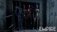 Batman, Flash, Cyborg and Wonder Woman stand in a doorway