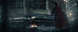 Zod kicks an oil truck at Superman