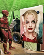 JL-BTS - Ezra Miller viewing a portrait of Harley Quinn on set