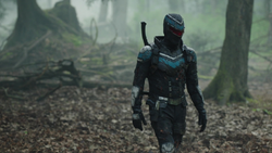 Vigilante talks with Economos in the forest