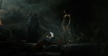 Batman and Wonder Woman stand over Lois cradling Superman's corpse