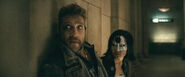 Captain Boomerang and Katana hide behind a wall