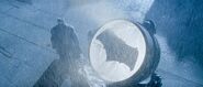 Batman stands by the Batsignal - promotional still