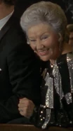 Mrs. Gordon portrayed by an uncredited actress in the Burtonverse.