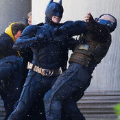 Christian Bale and Tom Hardy as Batman and Bane fighting on set.