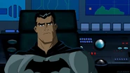 Bruce talks with Clark in the Batcave.
