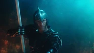 Orm holds his trident in the fight