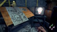 Billy sitting on the TV-set next to a table with sketches of Reverse Bear Traps on a previous version of The Game.