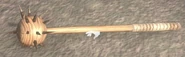 A wooden Morning Star on the ground in the original game