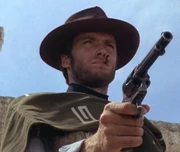 The Man with No Name aiming his pistol, ready to blow some poor sod's head off.