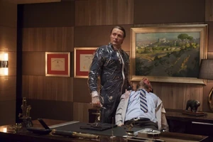 Hannibal notices he's being watched. Notice how he is wearing a plastic suit.