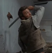 The Man with No Name about to throw his machete at an opponent