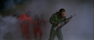 The chimpanzee rebel Caesar leading an attack on the humans, carrying an M16.