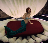 Tammy sits in a seashell in the Atlantica Casino.